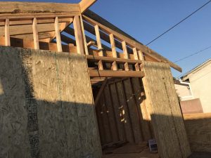Construction framing for a new home addition in Lakewood, CA. Shear wall framing connected to the stem wall foundation. Pacificland Constructors