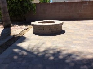 This outdoor fire pit is made with concrete pavers.