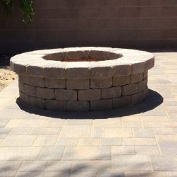 This outdoor fire pit is made with concrete pavers.