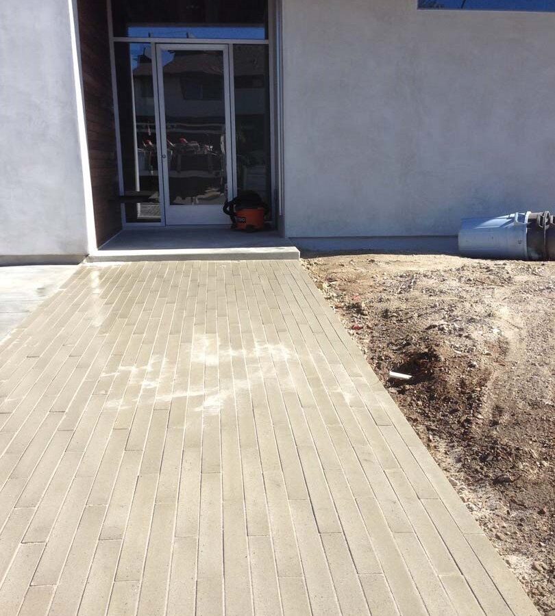 New commercial entrance built with long concrete pavers. Pacificland Constructors