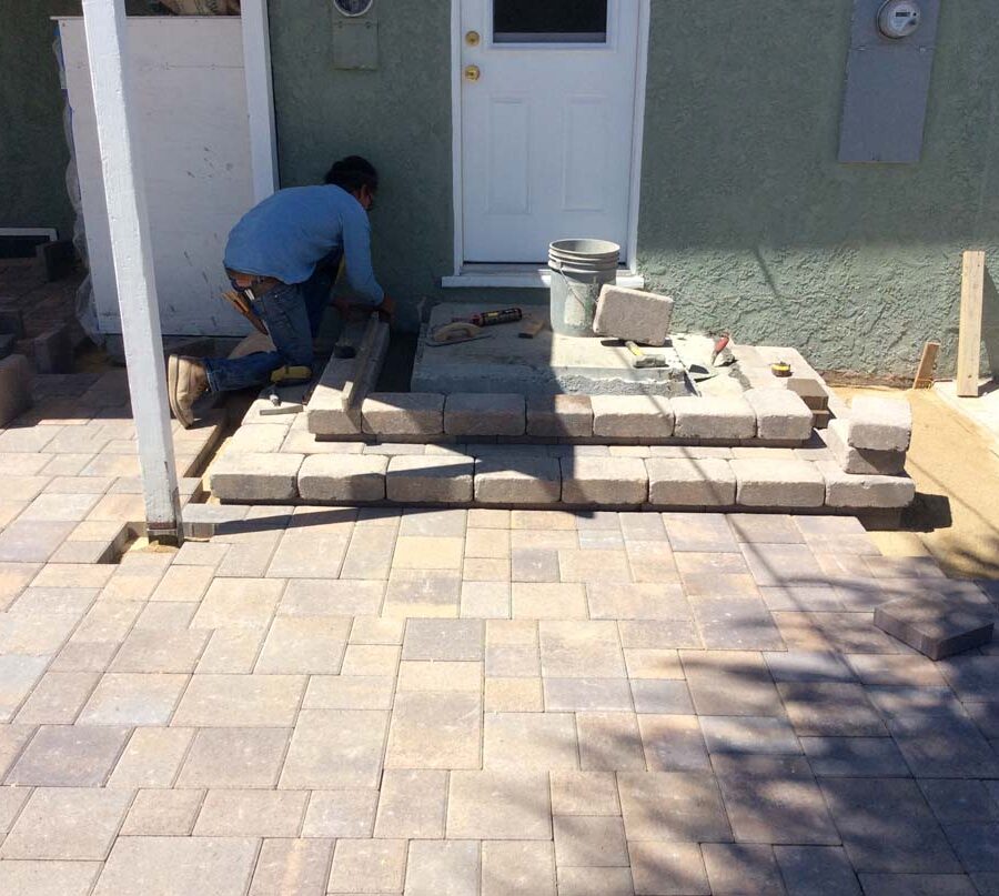 New paver concrete backyard patio, steps, and landing for a residential project.