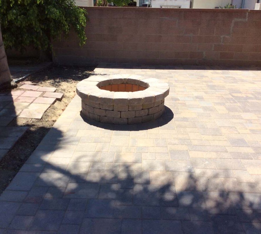 New paver concrete backyard and firepit for a residential project.