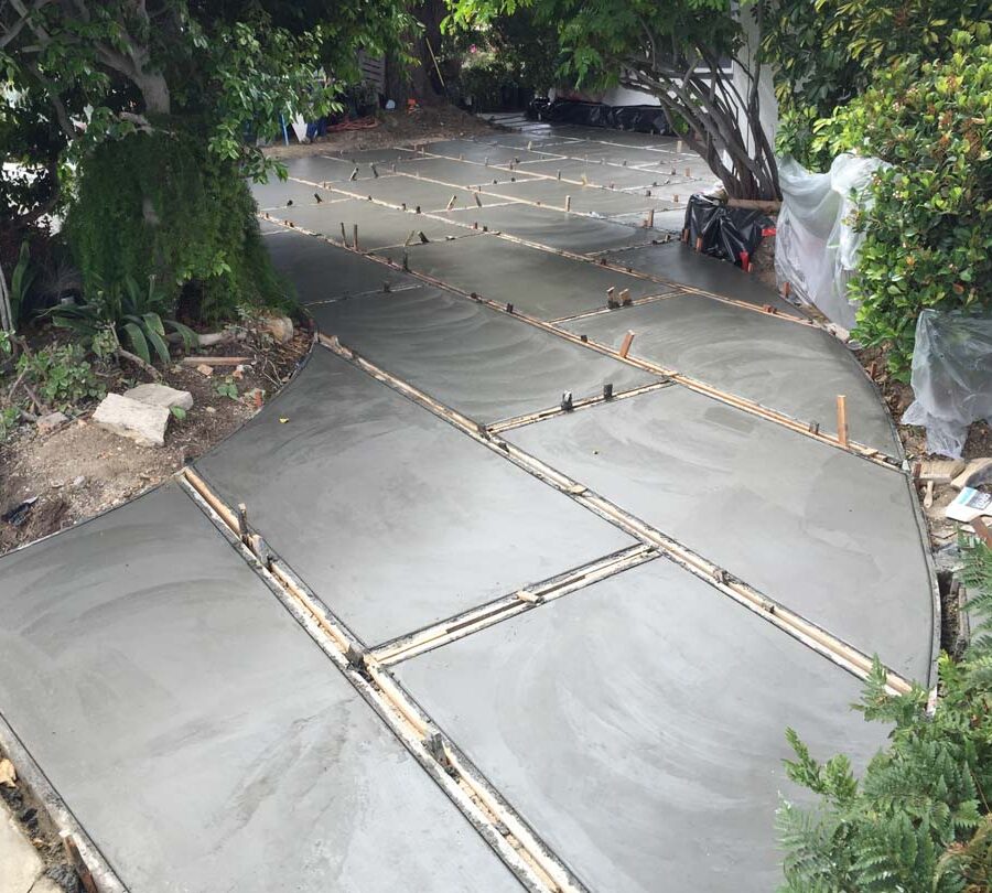 Pouring of a new front yard patio used to create an architecturally nature-friendly theme. Pacificland Constructors