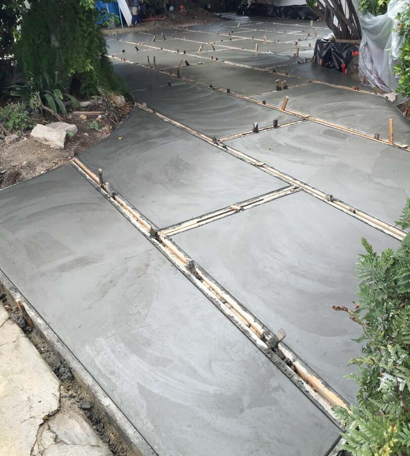 Pouring of a new front yard patio used to create an architecturally nature-friendly theme. Pacificland Constructors