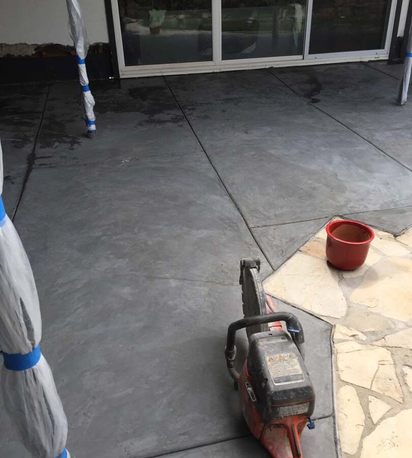 Use of a Kwik saw to cut joints into the new concrete slab.