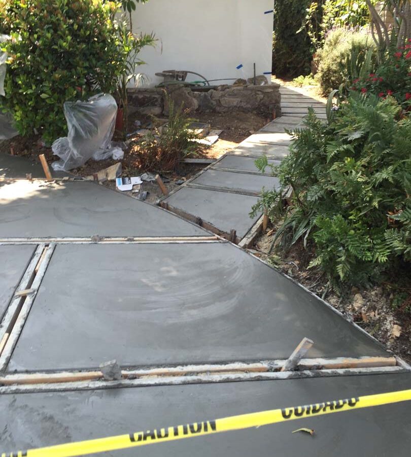 Pouring of a new front yard patio used to create an architecturally nature-friendly theme. Pacificland Constructors