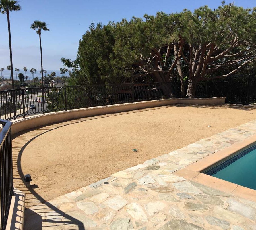 New DG landscaping, flagstone flatwork, and fence over a new retaining wall with concrete precast wall cap. Pacificland Constructors