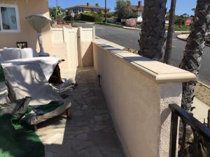 New stucco coated CMU wall with a precast wall cap. Pacificland Constructors