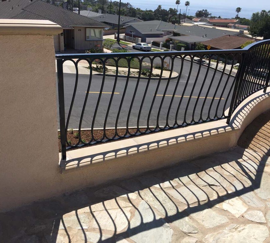 New DG landscaping, flagstone flatwork, and fence over a new retaining wall with concrete precast wall cap. Pacificland Constructors