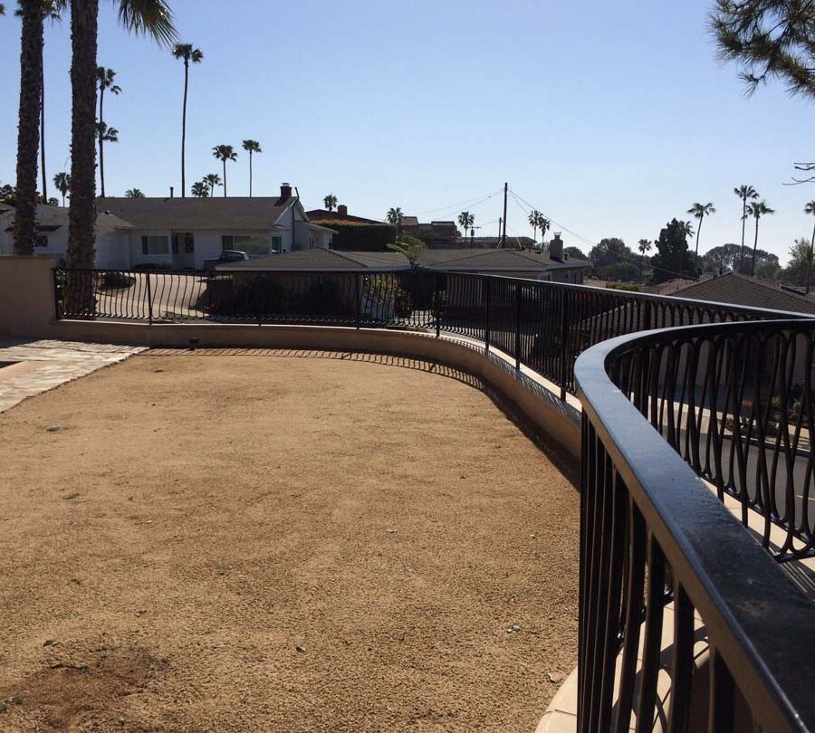 New DG landscaping and fence over a new retaining wall with concrete precast wall cap. Pacificland Constructors