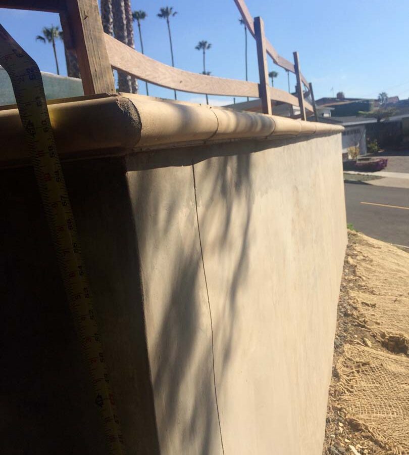 Construction of a new retaining wall with a colored concrete precast. Pacificland Constructors