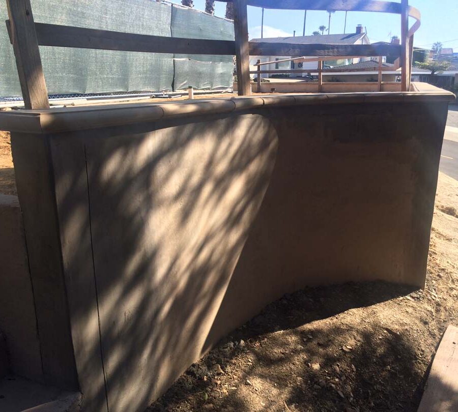 Construction of a new retaining wall with a colored concrete precast. Pacificland Constructors