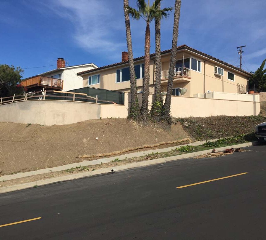 Construction of a new retaining wall with a colored concrete precast. Pacificland Constructors