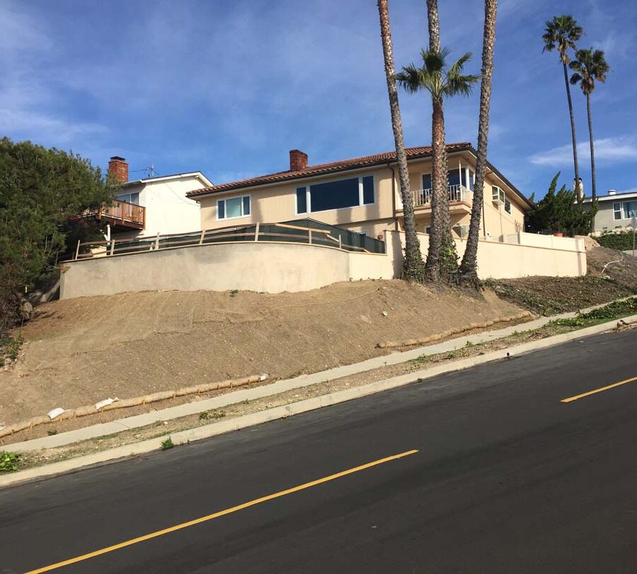 Construction of a new retaining wall with a colored concrete precast. Pacificland Constructors