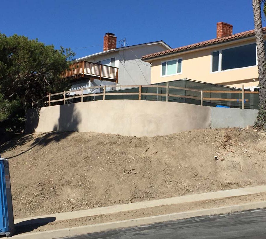 New retaining wall creating more flat area for a pool deck while simultaneously creating an open view for the owner. Pacificland Constructors