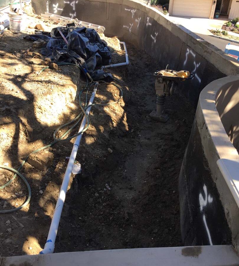 Waterproofing and pipe drainage that is buried is being compacted in place. New electrical pipe connections shown will also be buried out of sight. Pacificland Constructors