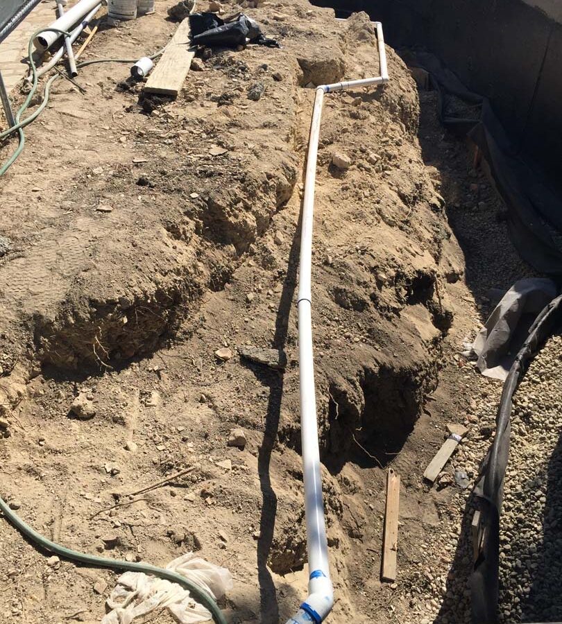 Waterproofing and pipe drainage that is buried is being compacted in place. New electrical pipe connections shown will also be buried out of sight. Pacificland Constructors