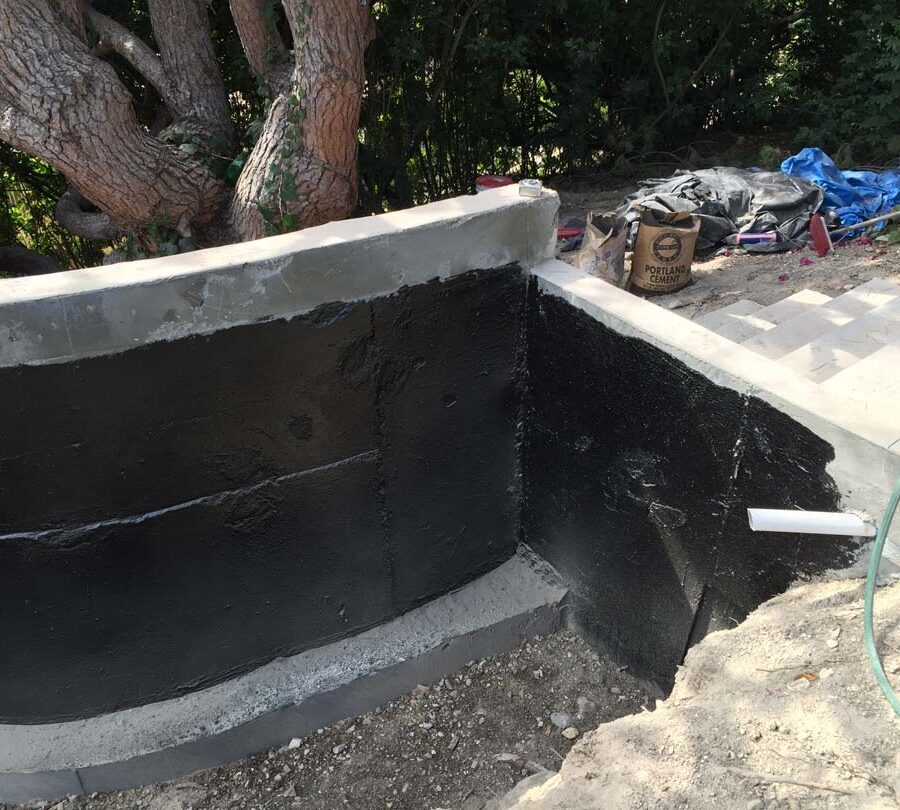 Construction of a new retaining wall application of waterproofing. Pacificland Constructors