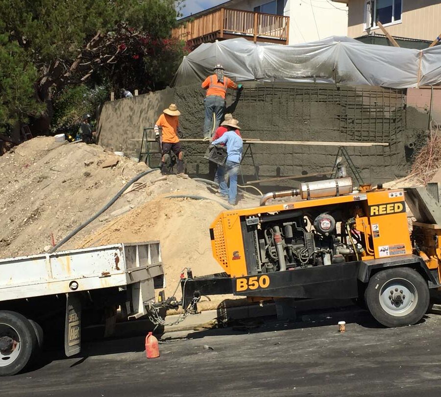 Construction of a new retaining wall shotcrete shooting. Pacificland Constructors