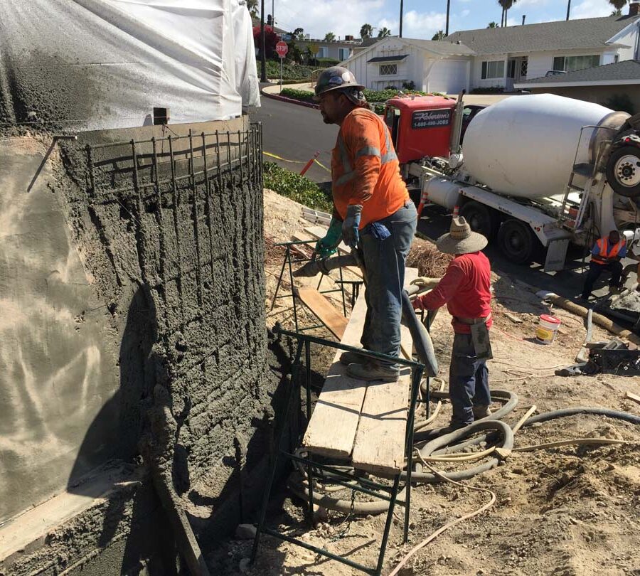 Construction of a new retaining wall shotcrete shooting. Pacificland Constructors