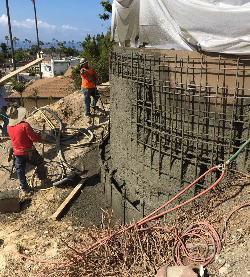 Construction of a new retaining wall shotcrete shooting and leveling. Pacificland Constructors