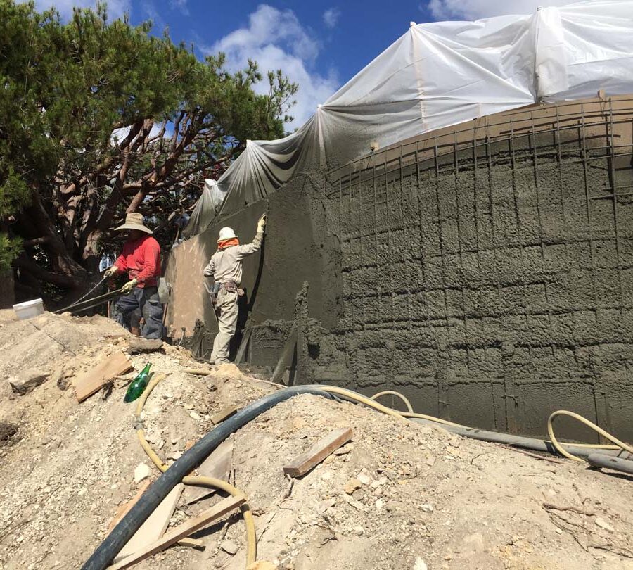 Construction of a new retaining wall shotcrete shooting and leveling. Pacificland Constructors