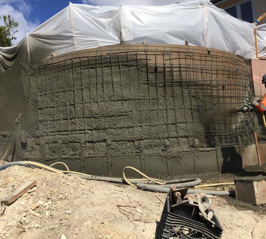 Construction of a new retaining wall shotcrete shooting and leveling. Pacificland Constructors