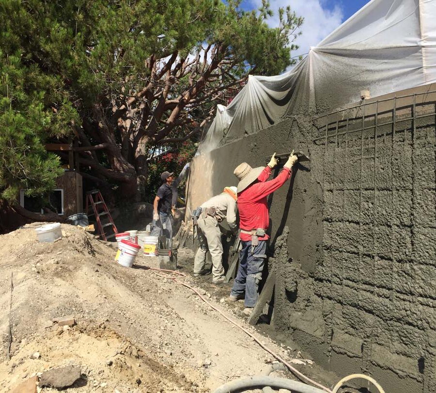 Construction of a new retaining wall shotcrete shooting and leveling. Pacificland Constructors