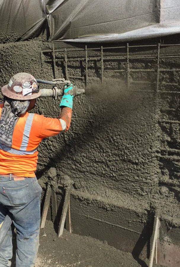 Construction of a new retaining wall shotcrete shooting. Pacificland Constructors