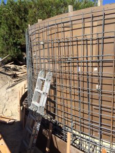 Construction of a new retaining wall steel rebar reinforcement. Pacificland Constructors