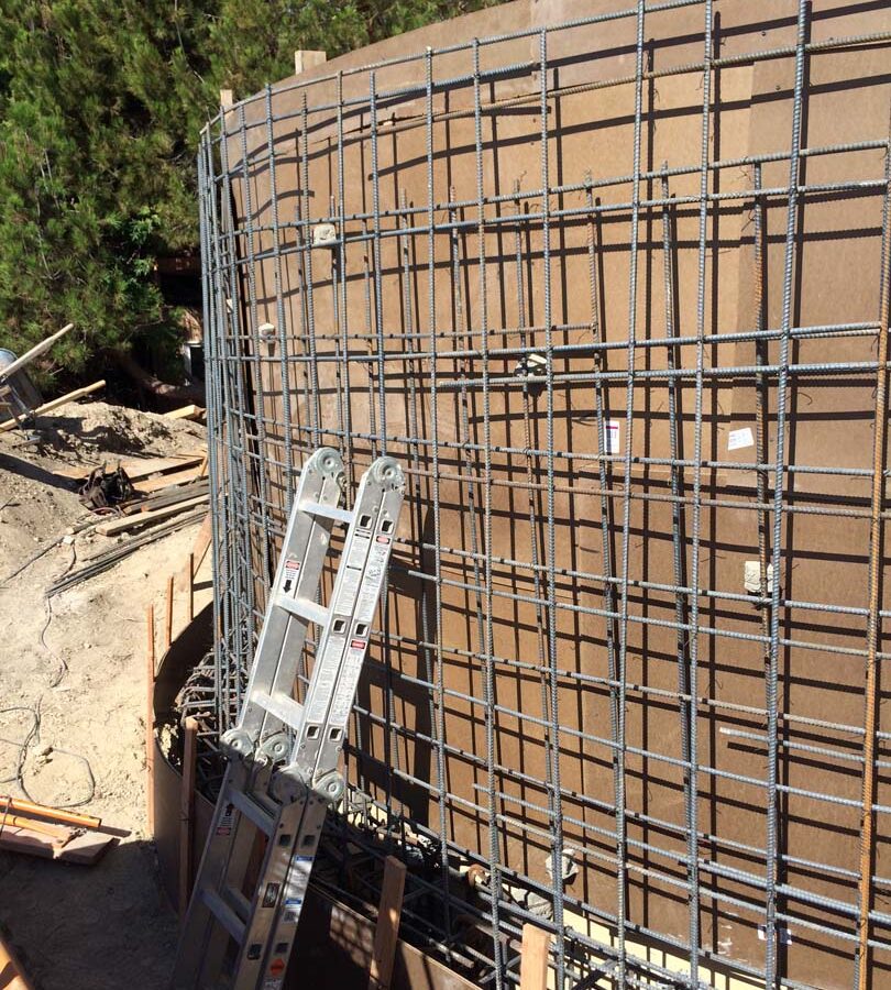 Construction of a new retaining wall steel rebar reinforcement. Pacificland Constructors