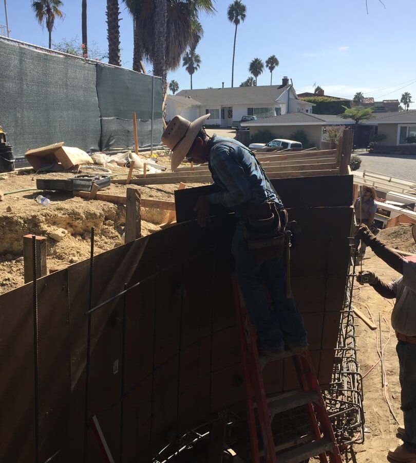 Construction of a new retaining wall steel rebar reinforcement. Pacificland Constructors