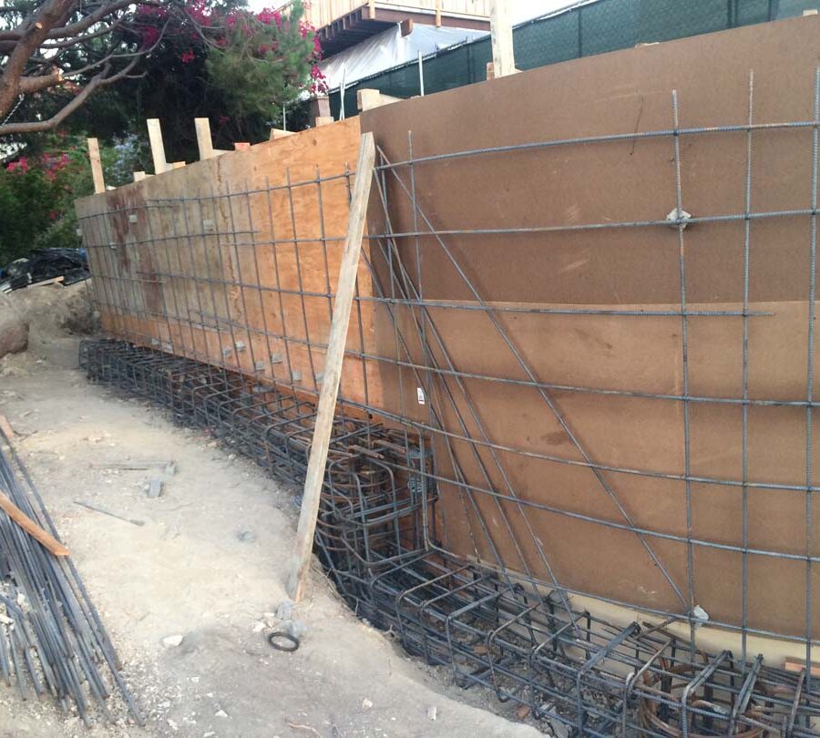 Construction of a new retaining wall steel rebar reinforcement for grade beam and retaining wall. Pacificland Constructors