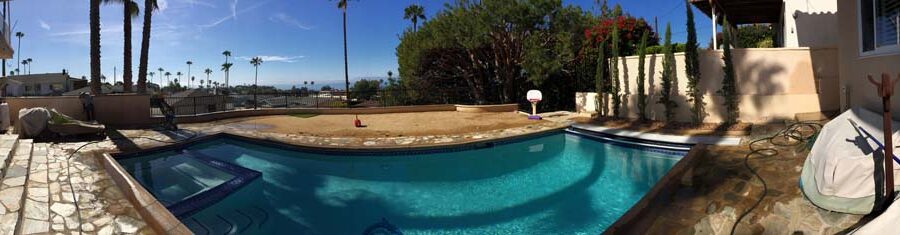 Panoramic view of the pool deck scenery over the retaining wall that was built by Pacificland Constructors.