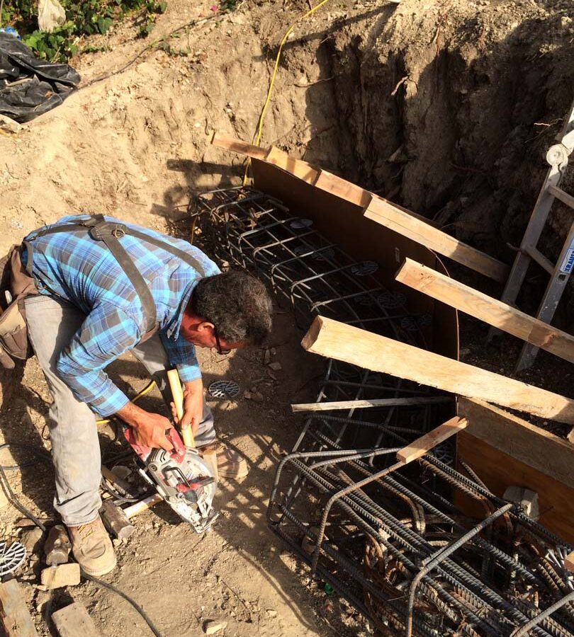 Construction of a new retaining wall steel rebar reinforcement for grade beam and formwork for the retaining wall. Pacificland Constructors