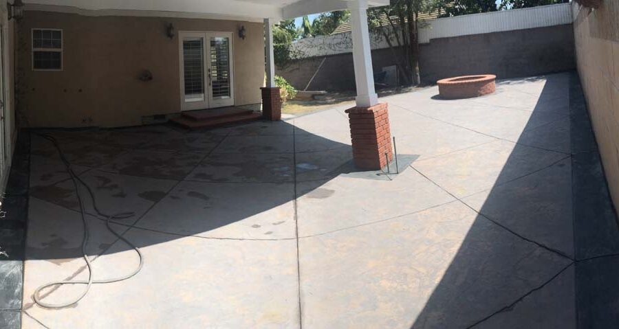 New stamped concrete with dark concrete ribbons and brick veneer columns. Pacificland Constructors