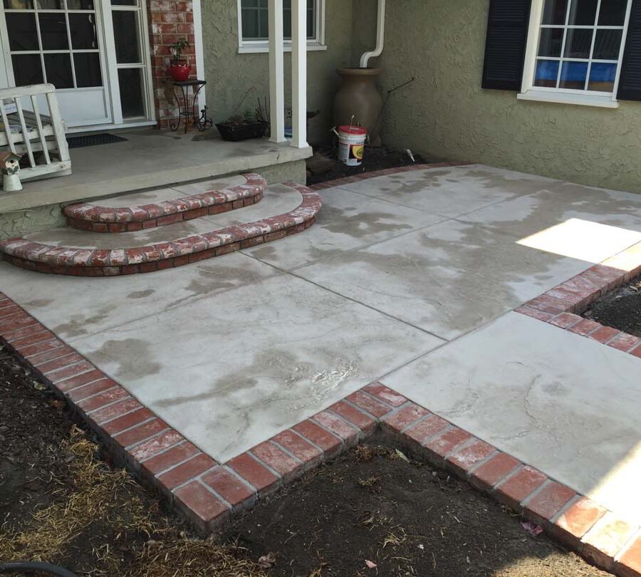 New backyard patio with manufactured white stained brick ribbons that creates a vintage look. Pacificland Constructors