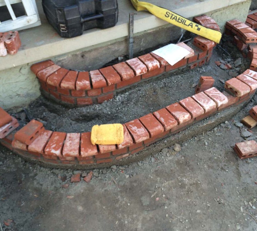 Construction of new brick steps with manufactured white stained brick that will create a vintage look. Pacificland Constructors