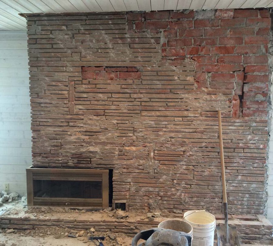 Demolition of existing veneer to prepare and reinforce the chimney for new Stone Veneer. Pacificland Constructors