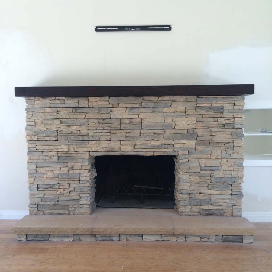 New stone veneer over the existing fireplace to create a vintage theme for the home. Pacificland Constructors