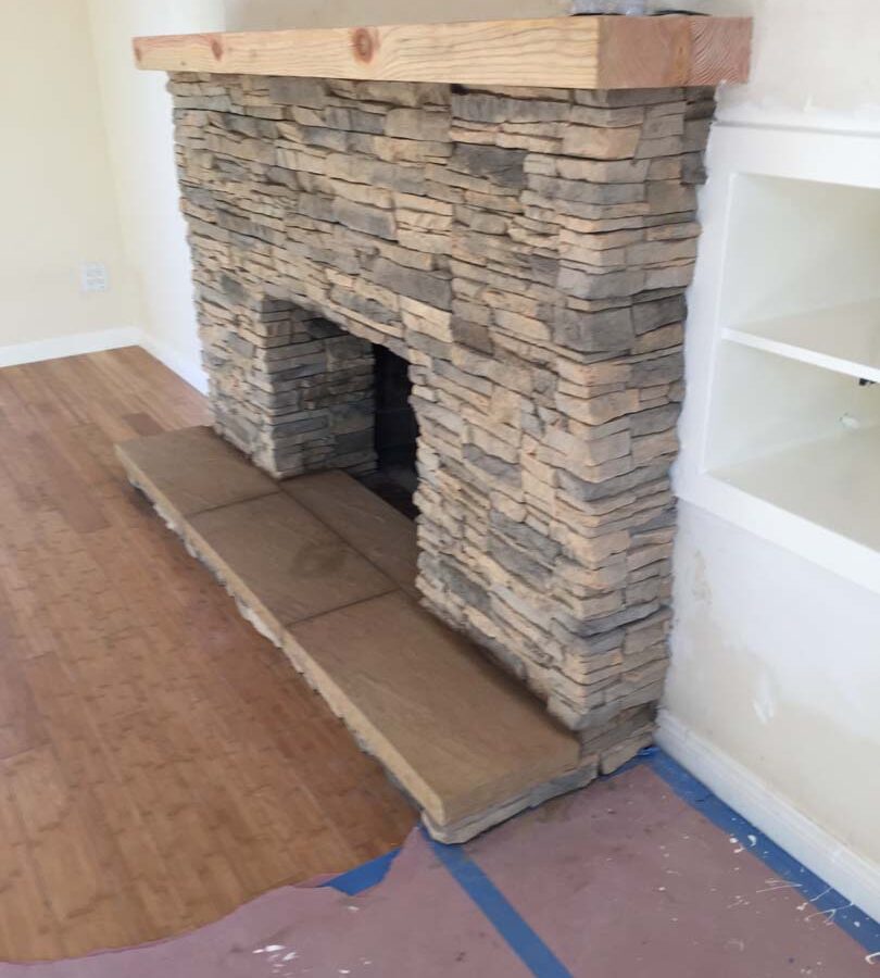 New stone veneer over the existing fireplace to create a vintage theme for the home. Pacificland Constructors