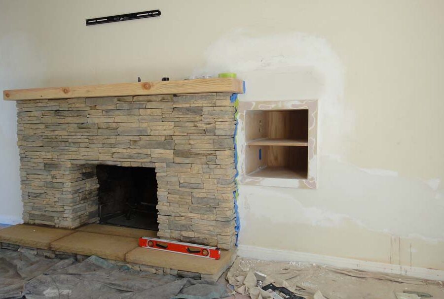 Construction for a stone veneer over the existing fireplace to create a vintage theme for the home. Pacificland Constructors