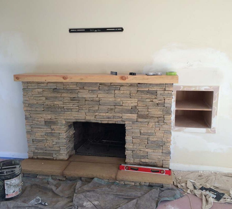 Construction for a stone veneer over the existing fireplace to create a vintage theme for the home. Pacificland Constructors