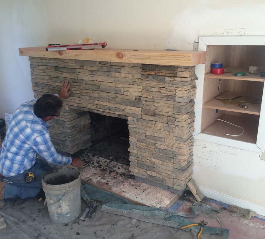 Construction for a stone veneer over the existing fireplace to create a vintage theme for the home. Pacificland Constructors