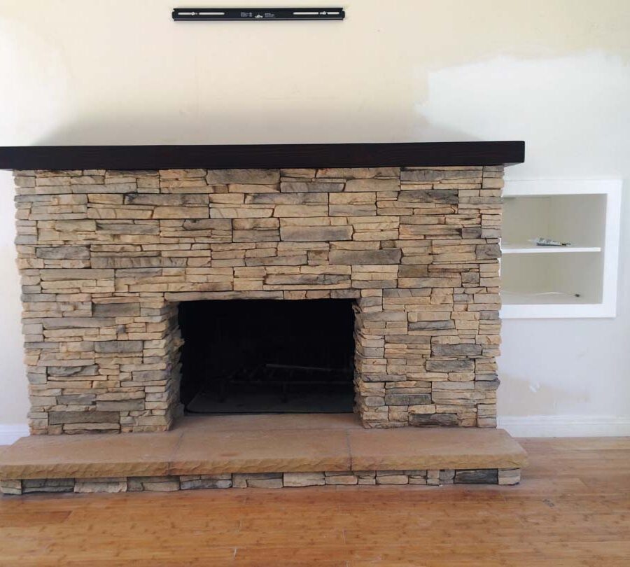 New stone veneer over the existing fireplace to create a vintage theme for the home. Pacificland Constructors