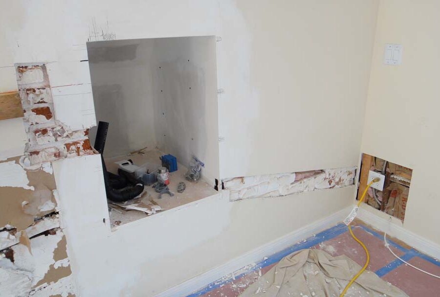 Demolition of the outdated fireplace for this home. Pacificland Constructors