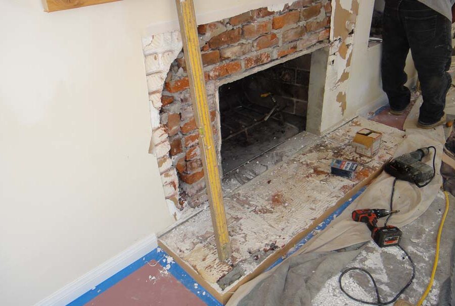 Demolition of the outdated fireplace for this home. Pacificland Constructors