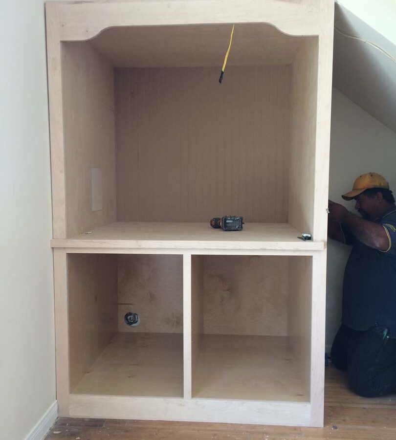 Construction of a new wooden drawer under the stairs of the home. Pacificland Constructors