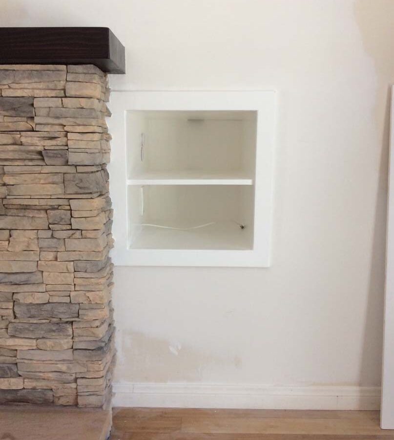 New stone veneer over the existing fireplace to create a vintage theme for the home. Pacificland Constructors