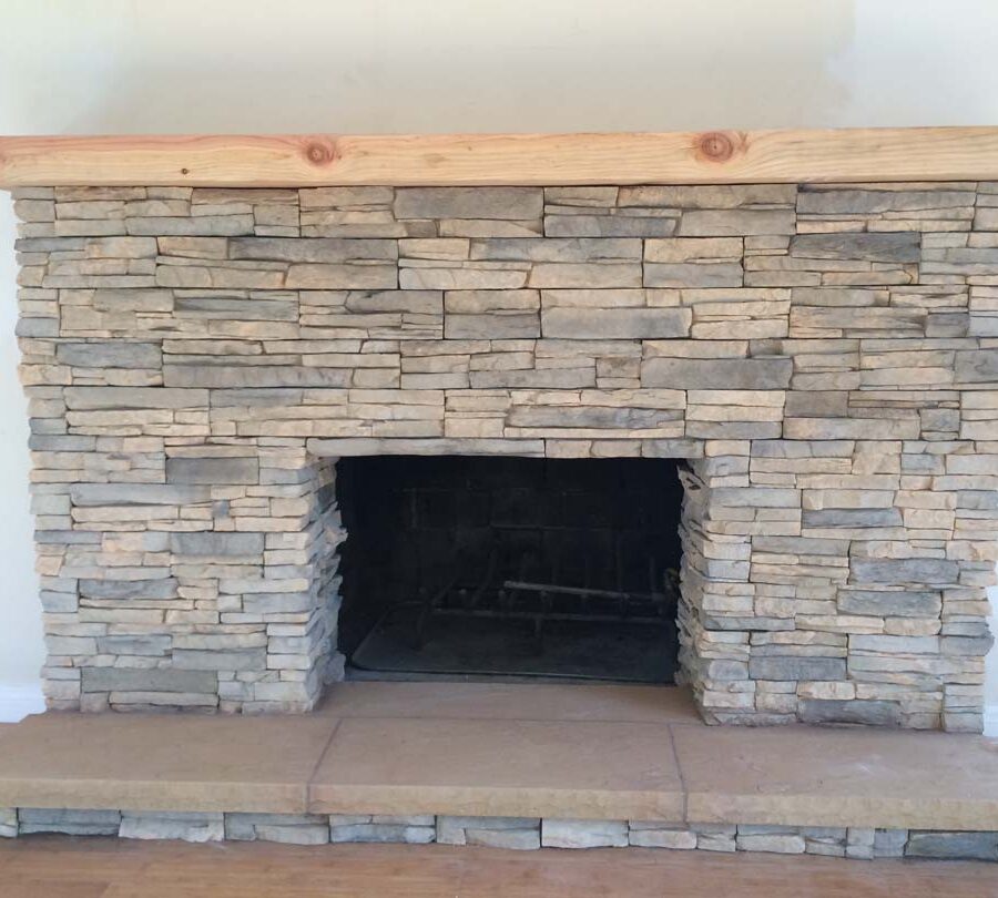 New stone veneer over the existing fireplace to create a vintage theme for the home. Pacificland Constructors